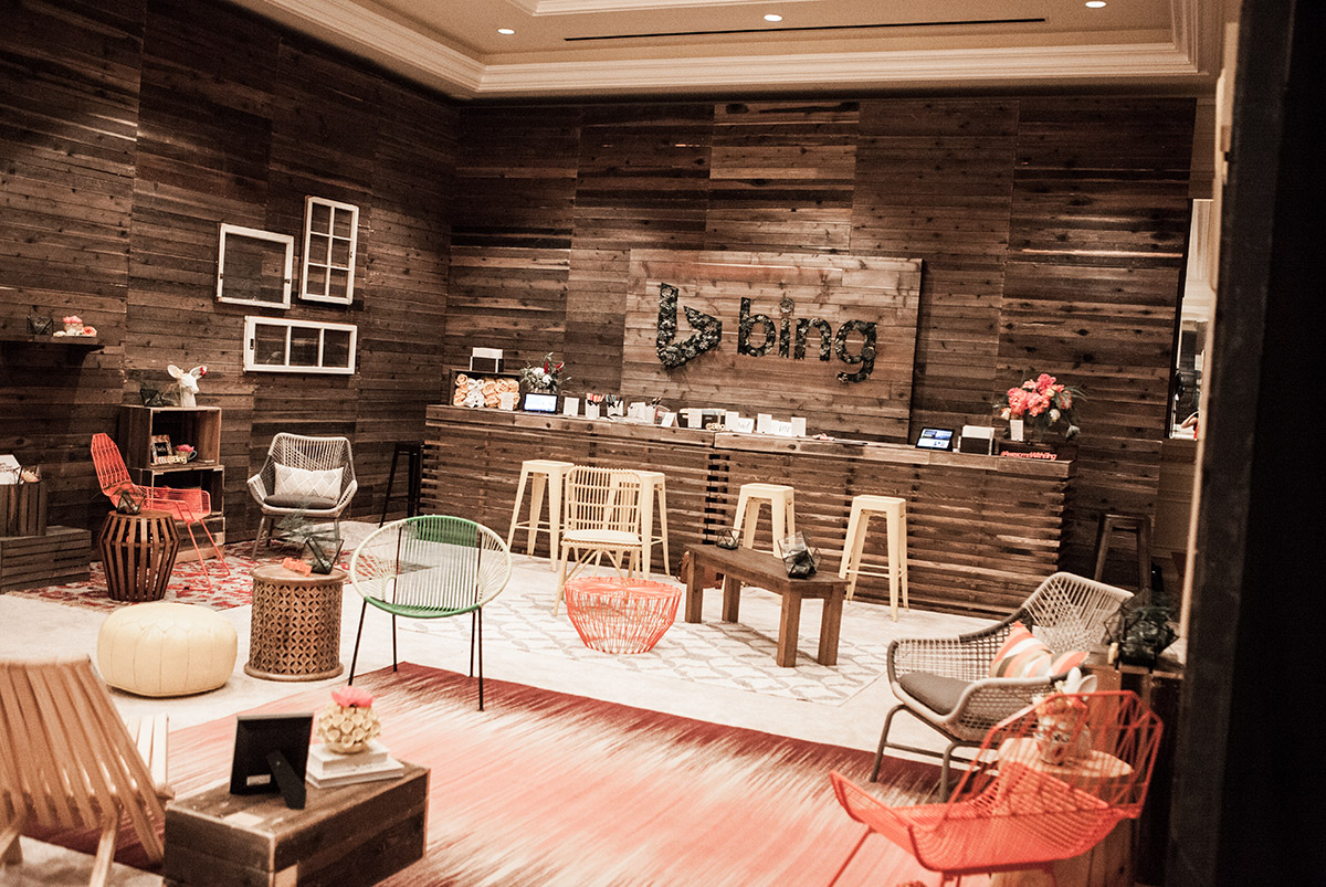 Wood paneled room with various chairs and tables and a wooden sign that says Bing