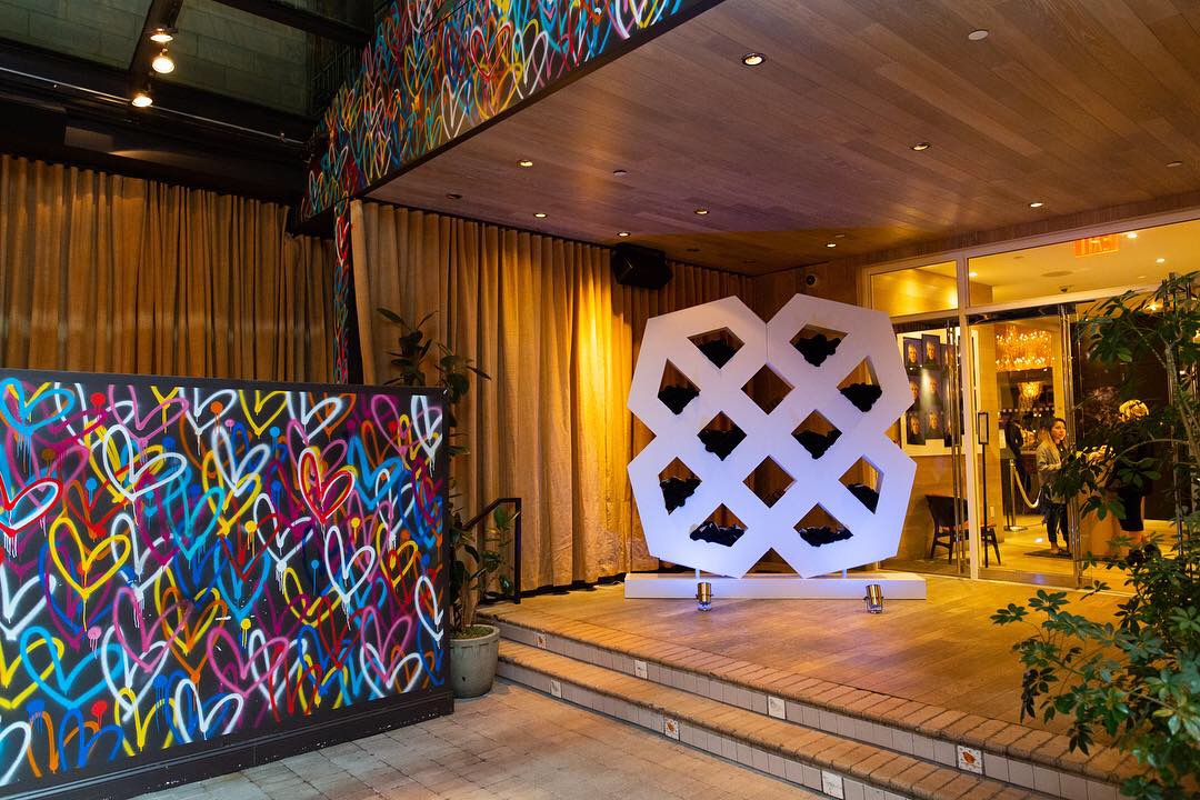 Entryway with graffiti heart wall and large white sculpture.
