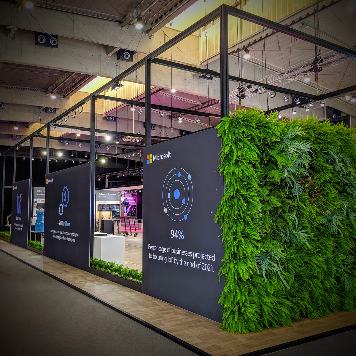 Microsoft trade booth with infographic and greenery wall.