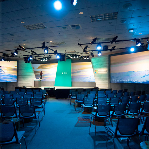 Large room with chairs in front of a stage with Bing branding.